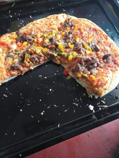 A picture of Vegetable and meat pizza.
