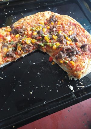 A picture of Vegetable and meat pizza.