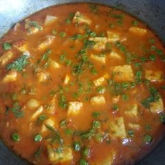 A picture of Paneer in Malai and tomato gravy.