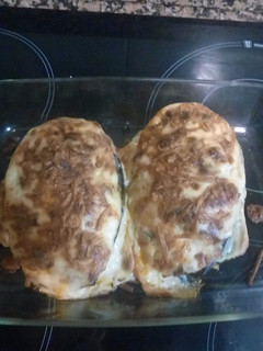 Una foto de Berenjena rellena de carne, virutas de jamón y queso
