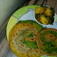 A picture of TRIANGA LUCHHA PARATHA and aloo curri.