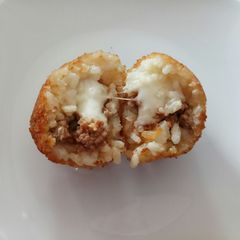 A picture of Arancini - mozzarella and ragù stuffed rice balls.