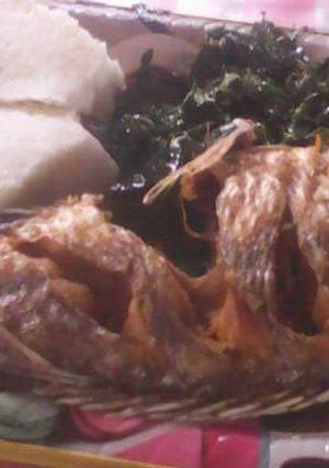 A picture of Fish stew with ugali.