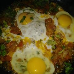 A picture of Eggs with onion tomatoes.