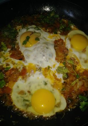 A picture of Eggs with onion tomatoes.