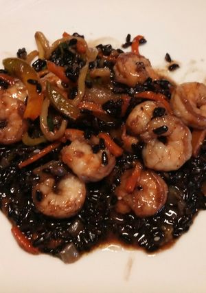 A picture of Stir fried mixed veg with black rice and prawns.