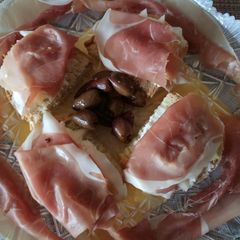A picture of Goat's cheese, pear and prosciutto bruschette.