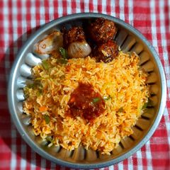 A picture of Schezwan fried rice with Manchurian balls.