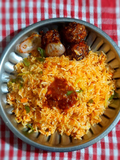 A picture of Schezwan fried rice with Manchurian balls.