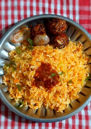 A picture of Schezwan fried rice with Manchurian balls.
