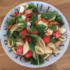 A picture of Feta, tomato, spinach pasta salad.
