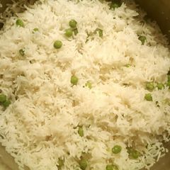 A picture of Boiled white rice with green peas 🍚☺.