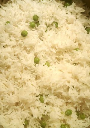 A picture of Boiled white rice with green peas 🍚☺.
