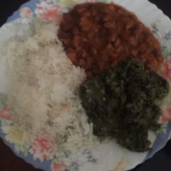 A picture of Mboga kienyeji, rice and beans.