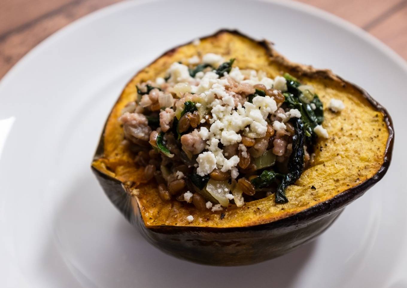 Roasted Acorn Squash with Sausage, Farro, Spinach, and Feta