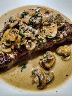 A picture of Steak with tarragon mushroom sauce.