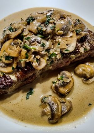 A picture of Steak with tarragon mushroom sauce.