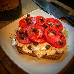A picture of Ricotta Toast with Tomatoes and Capers.