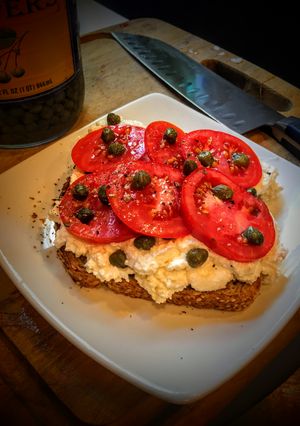 A picture of Ricotta Toast with Tomatoes and Capers.