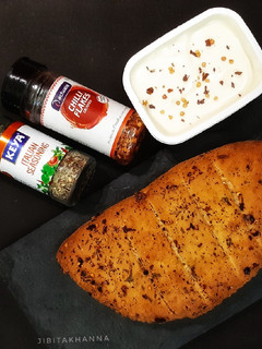 A picture of Garlic Bread with fresh basil (no oven bread).