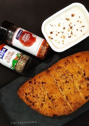 A picture of Garlic Bread with fresh basil (no oven bread).