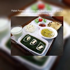 A picture of Palak Paneer with Tawa roti,daal tadka with jeera rice,Green salad and Minty Lasi.