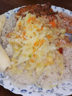 A picture of Rice and chicken stew with steamed cabbage.