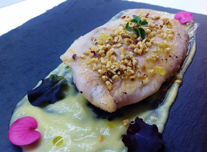Foto di Filetto di pesce persico su crema di acciughe e porro, e granella di nocciole tostate