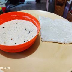 A picture of Coconut Chutney with Neer Dosa.