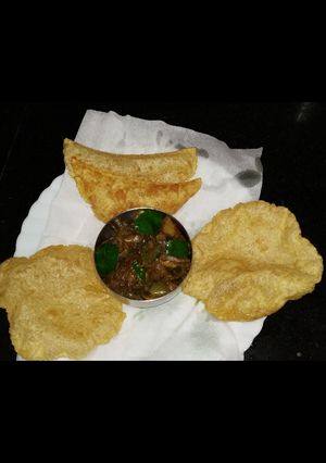 A picture of Stuffed egg burji poori.