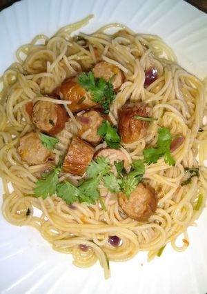 A picture of Fried sausages and spaghetti.