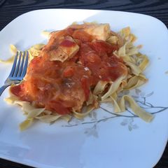 A picture of Baked halibut with tomato sauce.