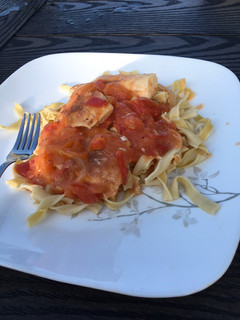 A picture of Baked halibut with tomato sauce.