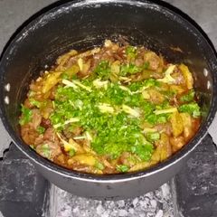 A picture of Desi beef karahi on wood.