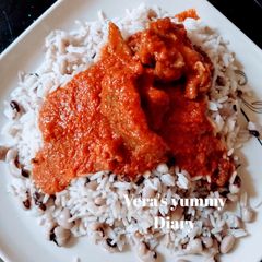 A picture of Rice/Beans and palm oil stew.