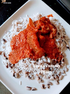 A picture of Rice/Beans and palm oil stew.