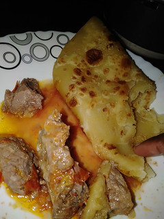 A picture of Chapati with beef stew.