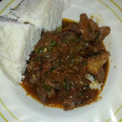 A picture of Fried meat with ugali.