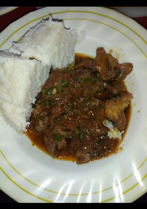 A picture of Fried meat with ugali.