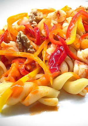 A picture of Fusilloni with Datterini Tomato Purée, Shrimp, Mini Peppers, and Walnuts.