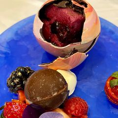Cube of Summer Pudding, optional, served inside a chocolate sphere A picture of Cube of Summer Pudding, optional, served inside a chocolate sphere.