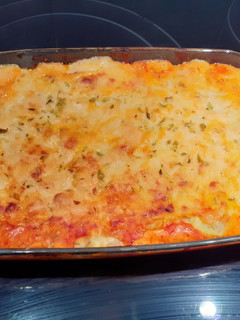 Una foto de Raviolis gratinados con queso cheddar