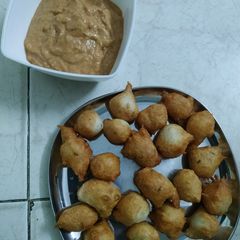 A picture of Punugulu with red chatnee(evening snacks).