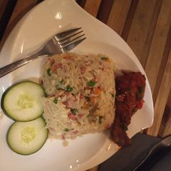 A picture of Coconut rice with fried fish.