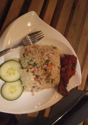 A picture of Coconut rice with fried fish.