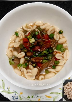A picture of Cowrie/ Kouri (Handmade cowrie shell shaped noodles) in Soup.
