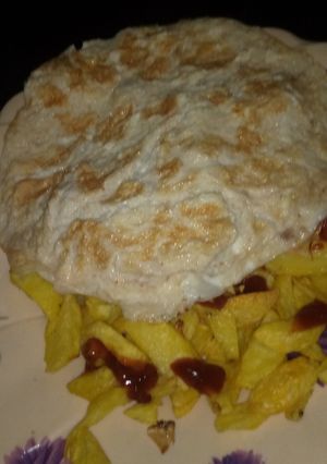 A picture of Fried arish with egg and ketchup.