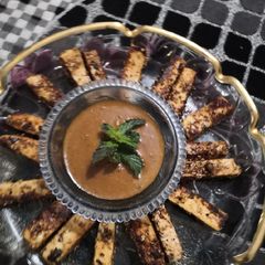 A picture of Paneer fingers with peanut sauce.