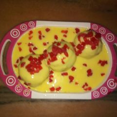 A picture of Custard with chocolate balls.