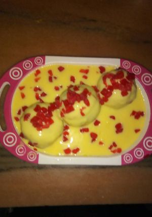 A picture of Custard with chocolate balls.